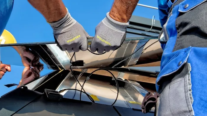 Technicians installing a solar panel