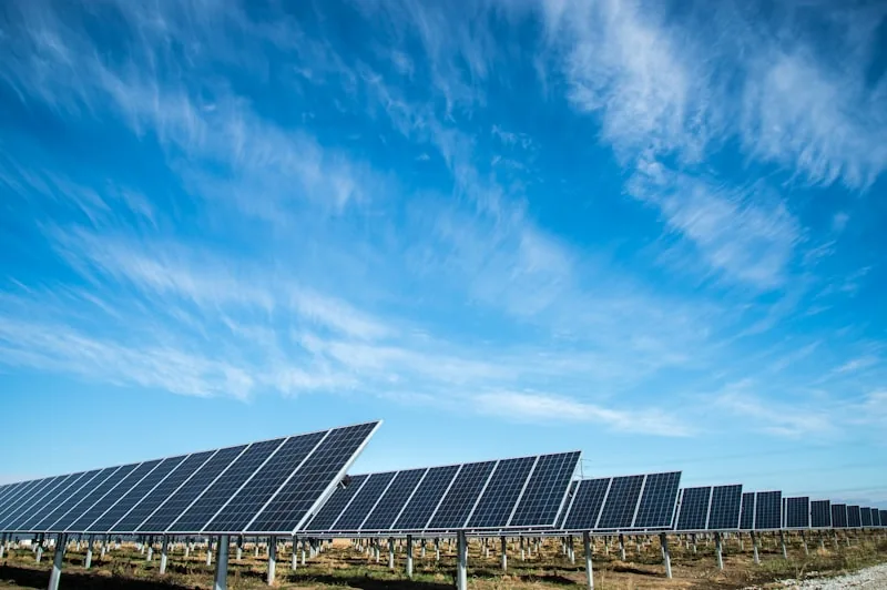 Residential rooftop solar panels under a clear blue sky